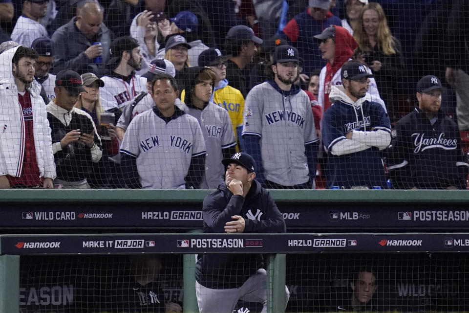 New York Yankees assistant hitting coach P.J. Pilittere lingers in the dugout after they were defeated by the Boston Red Sox 6-2 in an American League Wild Card playoff baseball game at Fenway Park, Tuesday, Oct. 5, 2021, in Boston. (AP Photo/Charles Krupa)