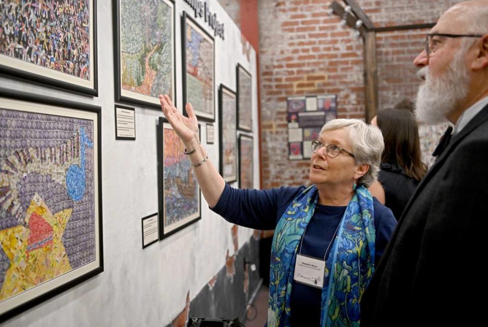 Charlotte Sheer talks to Rabbi David Ostrich Wednesday about the artwork out of stamps her students at Foxborough Regional Charter School made as part of the Holocaust Stamps Project. The American Philatelic Society’s new exhibit, “A Philatelic Memorial of the Holocaust,” features the project.