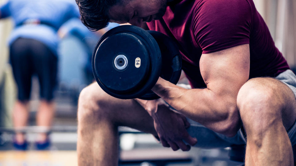 Man doing an arm workout with dumbbells