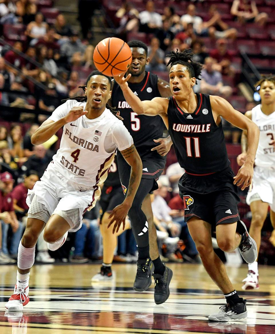 Dec 10, 2022; Tallahassee, Florida, USA; Louisville Cardinals guard Fabio Basili (11) fights for a loose ball as Florida State Seminoles guard Caleb Mills (4) pursues during the first half at Donald L. Tucker Center. Mandatory Credit: Melina Myers-USA TODAY Sports