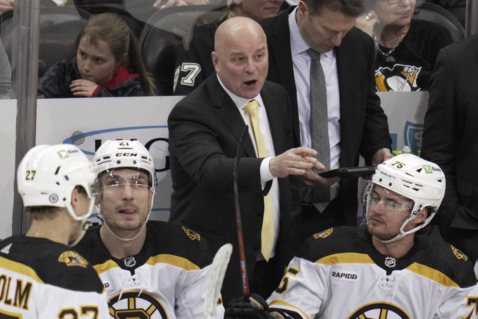 Boston Bruins head coach Jim Montgomery gives instructions during the first period of an NHL hockey game against the Pittsburgh Penguins in Pittsburgh, Saturday, April 1, 2023. The Bruins won 4-3. (AP Photo/Gene J. Puskar)