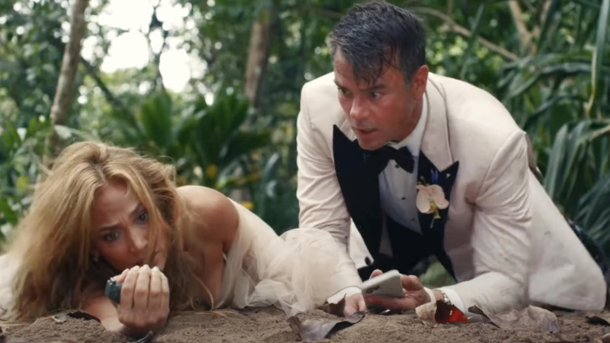  Jennifer Lopez gripping a live grenade while Josh Duhamel watches in Shotgun Wedding. 