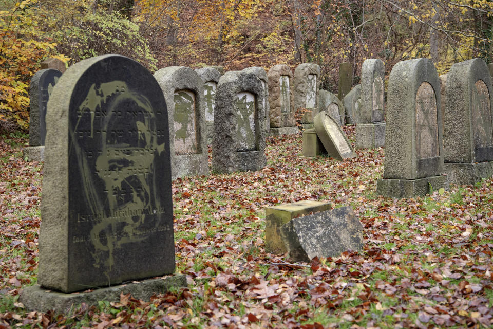 Tombstones vandalised at the jewish cemetery in Randers, Denmark, Sunday Nov. 10, 2019. More than 80 tombstones were vandalized at the jewish cemetery on Saturday with some 80 tombstones toppled or daubed with paint. (Bo Amstrup/Ritzau Scanpix via AP)