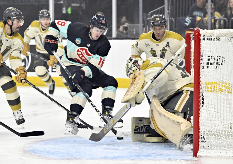 Seattle Kraken left wing Jared McCann (19) shoots on Vegas Golden Knights goaltender Logan Thompson (36) during the first period of an NHL hockey game Thursday, March 21, 2024, in Las Vegas. (AP Photo/David Becker)