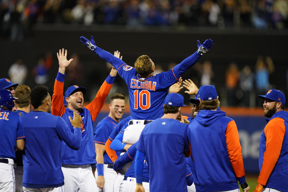 New York Mets' Eduardo Escobar (10) celebrates with teammates after hitting a walk-off single during the first inning of a baseball game against the Miami Marlins Wednesday, Sept. 28, 2022, in New York. The Mets won 5-4. (AP Photo/Frank Franklin II)