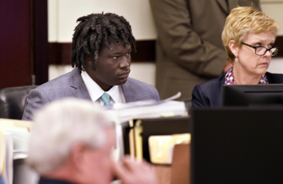 Emanuel Kidega Samson sits in court as the verdict is read in his murder trial Friday, May 24, 2019, in Nashville, Tenn. Samson was found guilty of first-degree murder in a shooting at a Nashville church two years ago that left a woman dead and seven wounded. Jurors deliberated less than five hours before finding Samson guilty on all 43 counts in the indictment. (Shelley Mays/The Tennessean via AP, Pool)