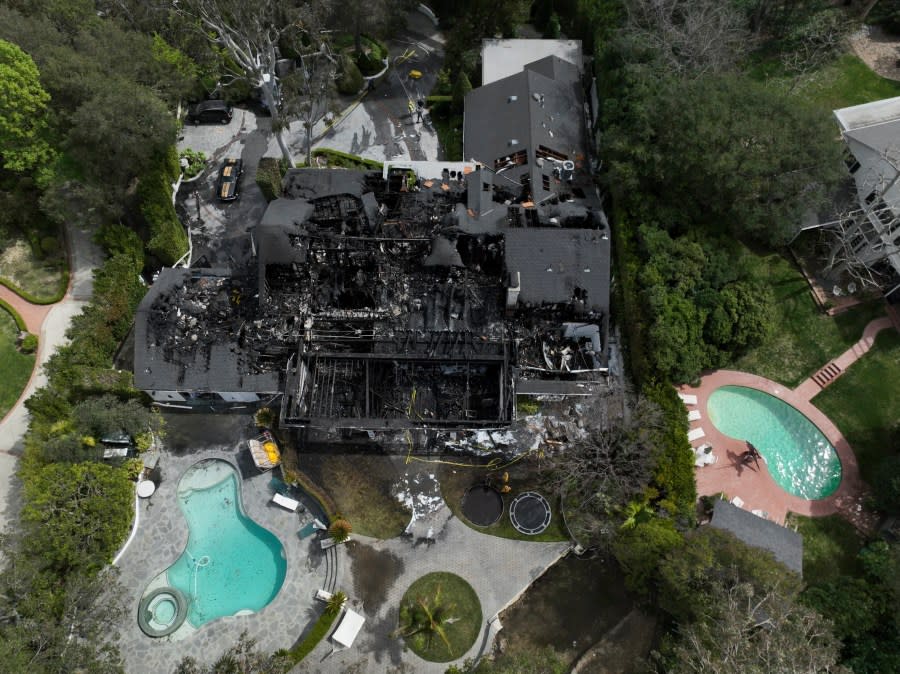 An aerial view shows a fire-damaged property, which appears to belong to Cara Delevingne, Friday, March 15, 2024, in the Studio City section of Los Angeles. (AP Photo/Jae C. Hong)