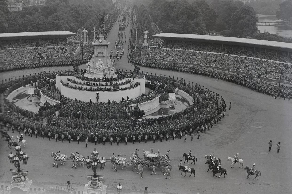 london june 2 the coronation of queen elizabeth ii the queen and the duke of edinburgh, in the gold state coach, pass cheering crowds on the queen victoria memorial, outside buckingham palace in london on june 2, 1953 photo by david levenson collectiongetty images