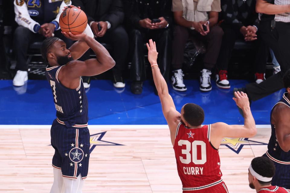 Eastern Conference guard Jaylen Brown (7) of the Boston Celtics shoots the ball against Western Conference guard Stephen Curry.