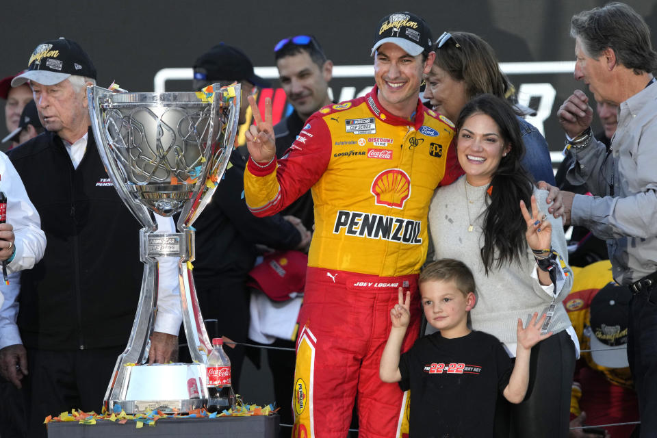 Joey Logano celebrates with his family after after winning a NASCAR Cup Series auto race and championship Sunday, Nov. 6, 2022, in Avondale, Ariz. (AP Photo/Rick Scuteri)