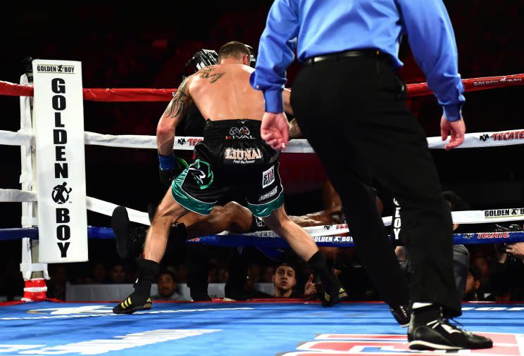 Joe Smith (back to camera) knocks Bernard Hopkins through the ropes, ending the 51-year-old legend's career Saturday in the eighth round of their bout at The Forum in Inglewood, Calif. (Getty Images)