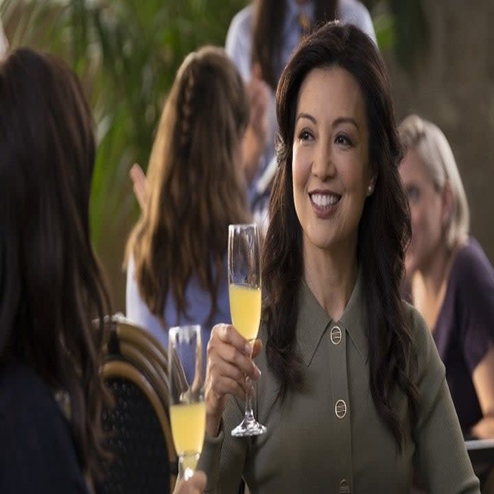 Elaine cheering mimosa glasses with Jessica Huang