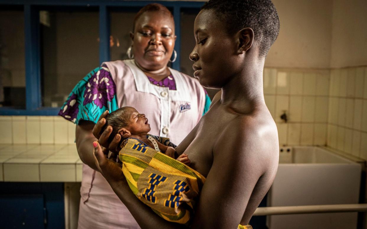 Seventeen year old Awa Coulibaly with one of her premature twins, assisted by midwife, Maimouna Coulibaly - Jason Florio 