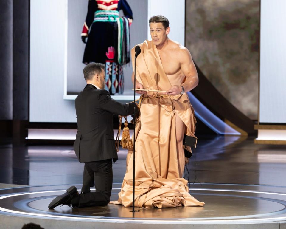 Kimmel doing a comedy bit with John Cena at the Oscars. DISNEY via Getty Images