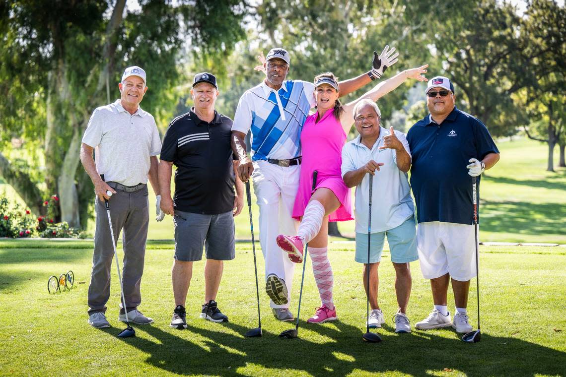 NBA legend Julius “Dr. J” Erving stands for a photo with Heather Manfredda, former World Long Drive champion, and his group, from left to right, John Daley, Wayne Tibke, Kim Modellas and Frank Mascarinas, as they participate in the Phil Oates Celebrity Golf Classic at North Ridge Country Club in Fair Oaks on Monday.