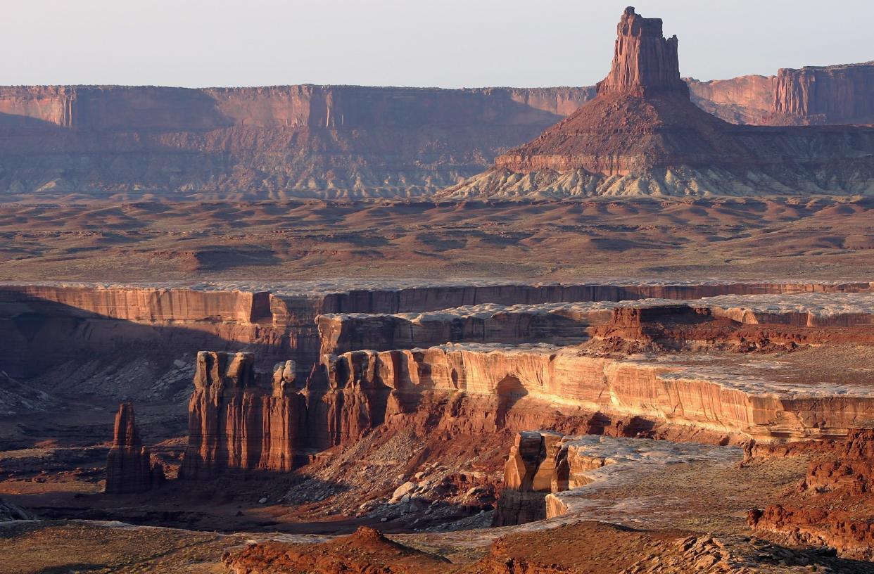 The Lower Basins Zone is outlined by the white rim edge as seen from the Murphy Campsite on the White Rim Trail on in Canyonlands National Park, Utah. Canyonlands – as the name suggests – is marked by the numerous canyons and other formations that have been cut into its colourful rock by the rivers that flow through it: Doug Pensinger/Getty Images