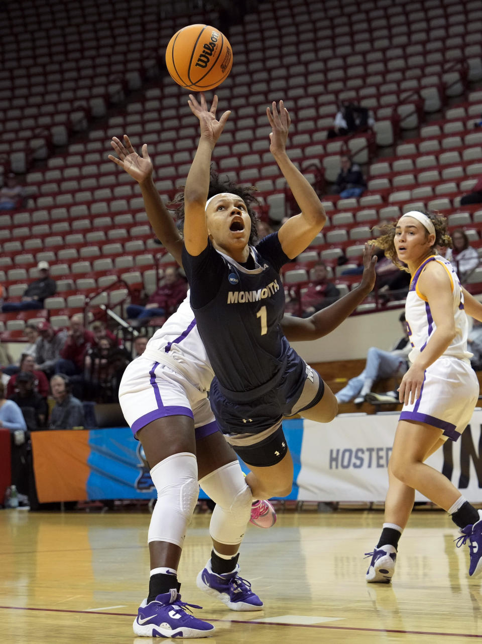 Monmouth guard Ariana Vanderhoop, right, shoots after being fouled by Tennessee Tech guard Reghan Grimes during the first half of a First Four college basketball game in the NCAA women's Basketball Tournament in Bloomington, Ind., Thursday, March 16, 2023. (AP Photo/AJ Mast)