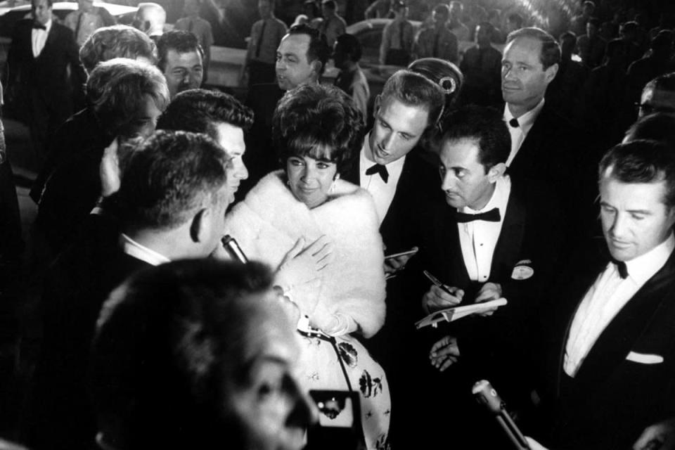 Elizabeth Taylor walks through a crowd of admirers at the Oscars in 1961 — the year she won her first Academy Award, for her role in Butterfield 8. (Grey Villet—Time & Life Pictures/Getty Images) <br> <br> <a href="http://life.time.com/culture/oscars-classic-photos-from-hollywoods-biggest-night/#1" rel="nofollow noopener" target="_blank" data-ylk="slk:Click here to see the full collection at LIFE.com;elm:context_link;itc:0;sec:content-canvas" class="link ">Click here to see the full collection at LIFE.com</a>