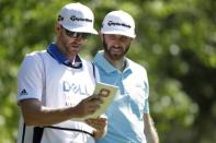 Mar 23, 2017; Austin, TX, USA; Dustin Johnson of the United States, right, goes over the yardage book with his caddie and brother Austin Johnson while playing against Martin Kaymer (not pictured) of Germany during the second round of the World Golf Classic - Dell Match Play golf tournament at Austin Country Club. Erich Schlegel-USA TODAY Sports