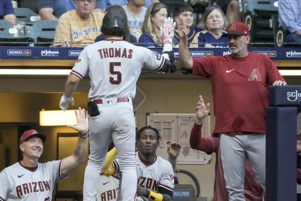 Arizona Diamondbacks' Alek Thomas is congratulated after hitting a two-run home run during the first inning of a baseball game against the Milwaukee Brewers Monday, June 19, 2023, in Milwaukee. (AP Photo/Morry Gash)
