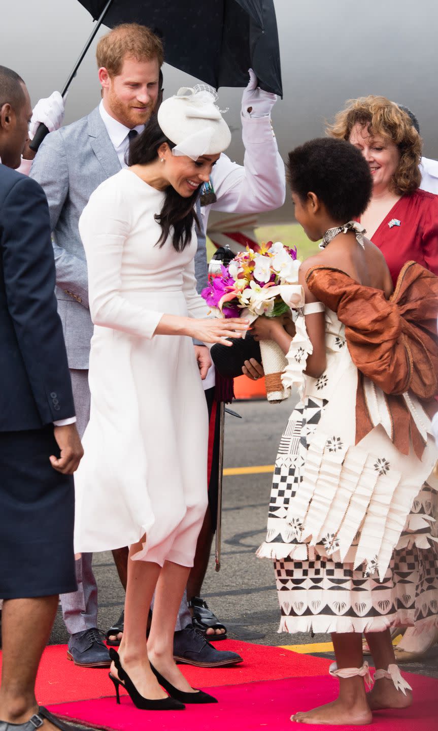<p>The Duchess receives a bouquet upon arriving at the airport.</p>