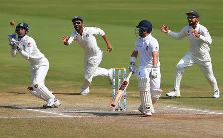 Cricket - India v England - Second Test cricket match - Dr. Y.S. Rajasekhara Reddy ACA-VDCA Cricket Stadium, Visakhapatnam, India - 21/11/16. India's Wriddhiman Saha (L) takes a catch to dismiss England's Ben Duckett. REUTERS/Danish Siddiqui