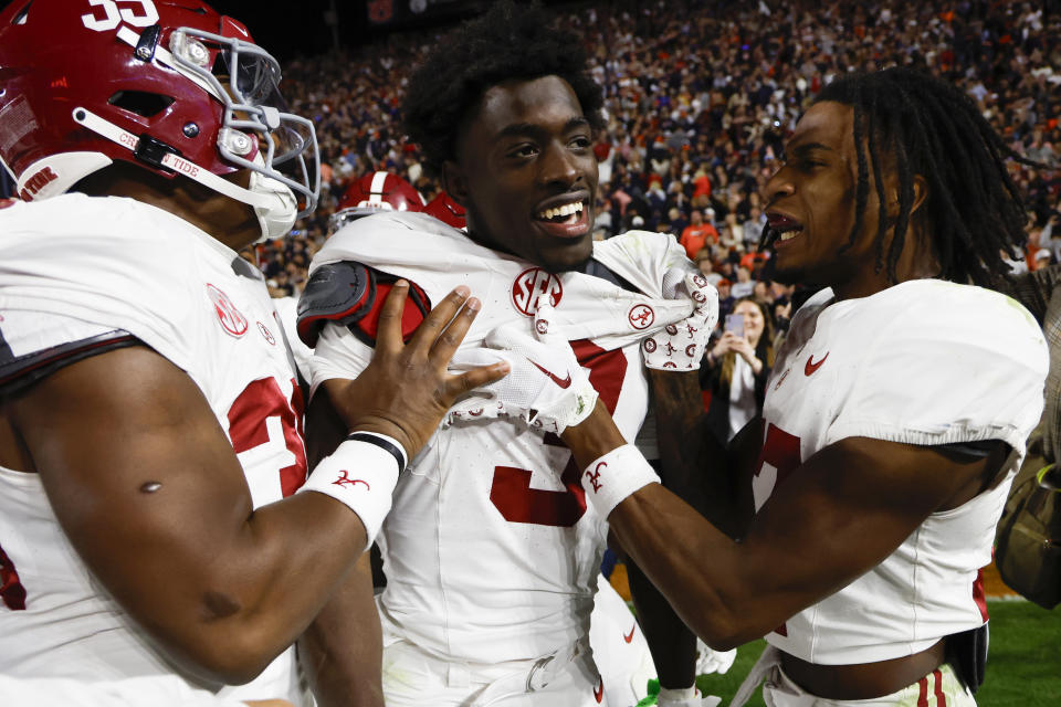 FILE - Alabama defensive back Terrion Arnold (3) celebrates with linebackers Jeremiah Alexander, left, and Trezmen Marshall, right, after an interception in athe second half of an NCAA college football game against Auburn, Saturday, Nov. 25, 2023, in Auburn, Ala. Arnold is a possible first round pick in the NFL Draft. (AP Photo/Butch Dill, File)