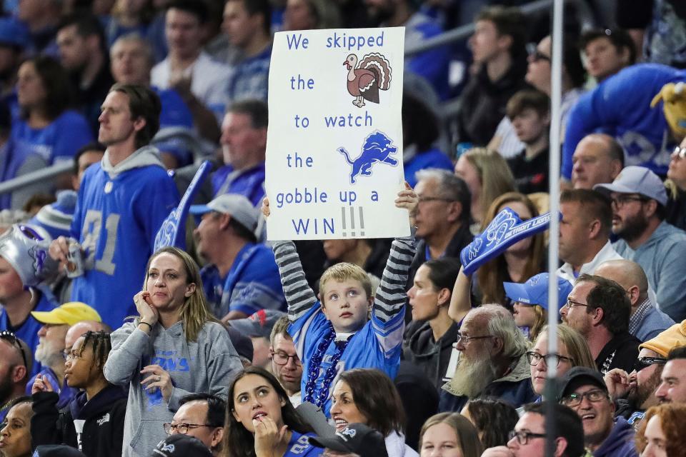 Detroit Lions fan holds up a sign during a game against the Green Bay Packers on Thanksgiving Day at Ford Field in Detroit on Thursday, Nov. 23, 2023.