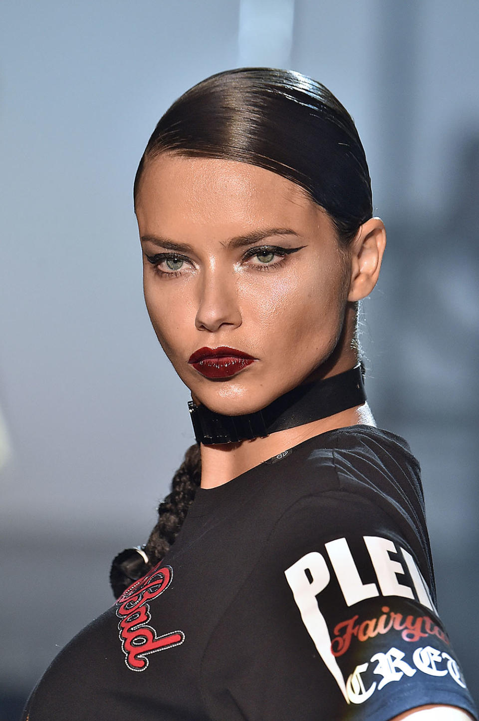 <p>Paired with a graphic cat eye, this glossy dark red lip creates a vampy effect on Adriana Lima. On this runway, makeup looks were individualized, and no two were exactly the same.(Photo: Getty Images) </p>