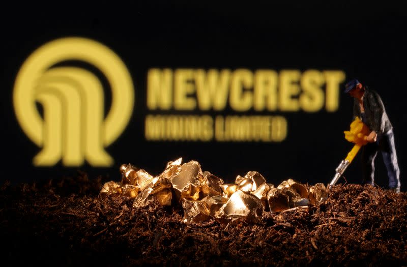 FILE PHOTO: Small toy figure and imitation gold are seen in front of the Newcrest logo in this illustration