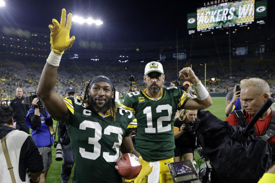 Green Bay Packers running back Aaron Jones (33) and quarterback Aaron Rodgers (12) walk off the field after an NFL football game against the Chicago Bears Sunday, Sept. 18, 2022, in Green Bay, Wis. The Packers won 27-10. (AP Photo/Mike Roemer)