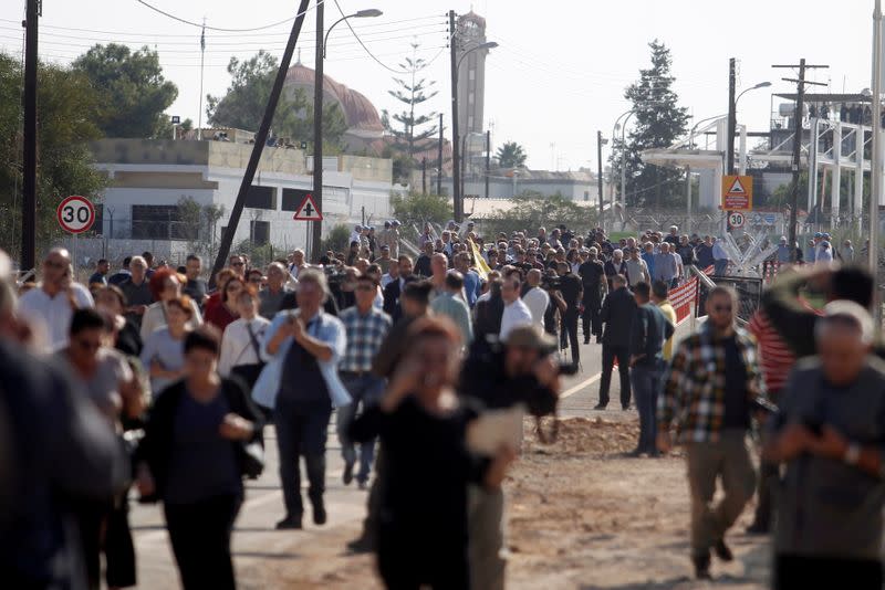 FILE PHOTO: People cross at newly opened checkpoint in Dherinia