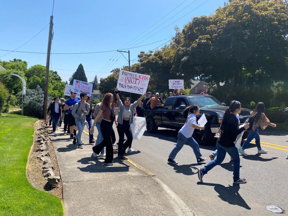 Students march near South Salem High School in a joint effort to support North Salem High students who allege abuse by a teacher and former coach.