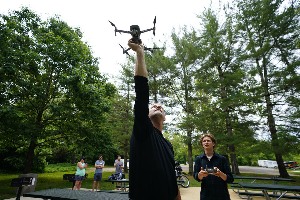 Brent Walls, left, the Upper Potomac Riverkeeper with Potomac Riverkeeper Network, teaches Robby Lewis-Nash, a staff writer with Friends with Casco Bay in Portland, Maine, how to catch a drone with his hand during a training session, Tuesday, June 7, 2022, in Poolesville, Md. They work to protect rivers and waterways and have begun using drones to catch polluters in places where wrongdoing is difficult to see or expensive to find. The images they capture have already been used as evidence to formally accuse companies of wrongdoing. (AP Photo/Julio Cortez)