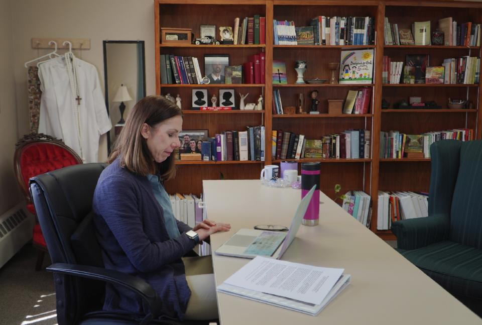 The Rev. Jillene Gallatin, of Grace Lutheran Church, prays with her fellow clergy members at the start of their online suicide prevention course, in Waseca, Minn., on Thursday, May 4, 2023. For Gallatin, the call to prevention is excruciatingly personal. At age 15, she tried to kill herself a year after her mother took her own life. And it was in her church that she found comfort and a listening ear. (AP Photo/Jessie Wardarski)