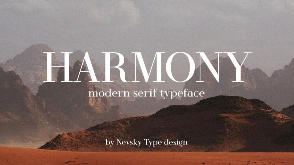 A shot of a typeface against a mountain that says harmony