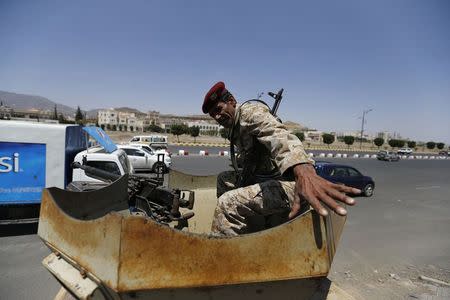A member of the presidential guard force rides atop a patrol vehicle positioned at a checkpoint near the Presidential Palace in Sanaa September 24, 2014. REUTERS/Khaled Abdullah