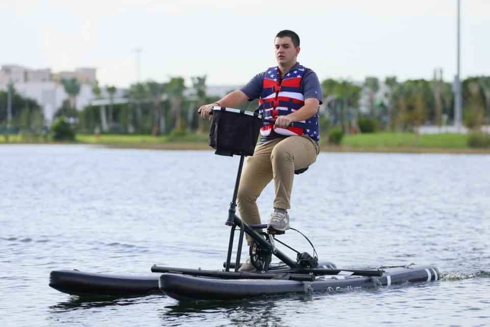 Fabrizio Prato, 24, rides a water bike on the lake of the newly inaugurated eastern portion of Doral Central Park at 3005 NW 92nd Ave. in Doral, Florida, on Monday, Aug. 26, 2024.