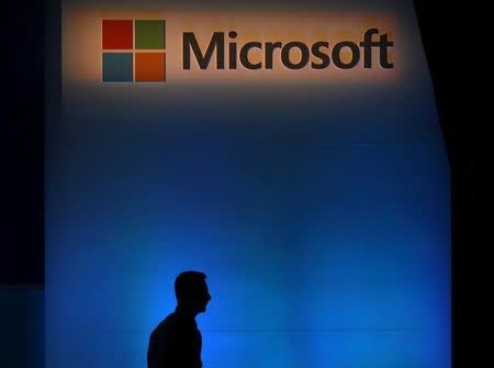 A shadow is cast near the Microsoft logo at the 2015 Computex exhibition in Taipei, Taiwan, June 3, 2015. REUTERS/Pichi Chuang