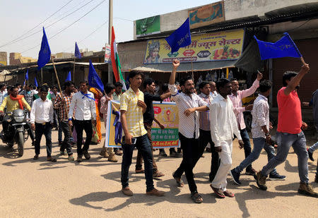 FILE PHOTO: People belonging to the Dalit community shout slogans as they take part in a nationwide strike called by several Dalit organisations, in Kasba Bonli, in Rajasthan, India, April 2, 2018. REUTERS/Krishna N. Das