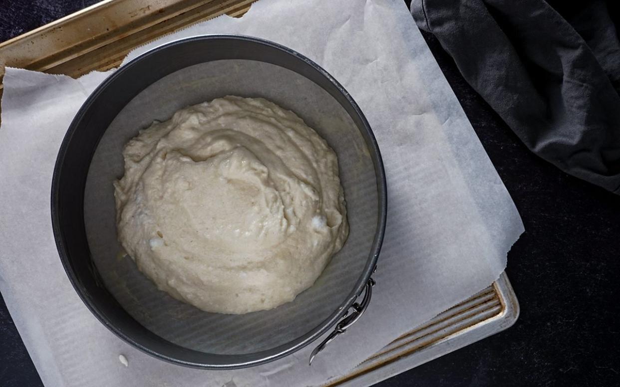 dividing dacquoise batter evenly between two springform cake pans