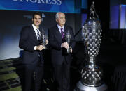 Will Power, left, winner of the 2018 Indianapolis 500, holds his "Baby Borg" driver's trophy as he stands with Roger Penske, who holds his team owner's trophy, in Detroit, Wednesday, Jan. 16, 2019. At right is the Borg-Warner Trophy. (AP Photo/Paul Sancya)