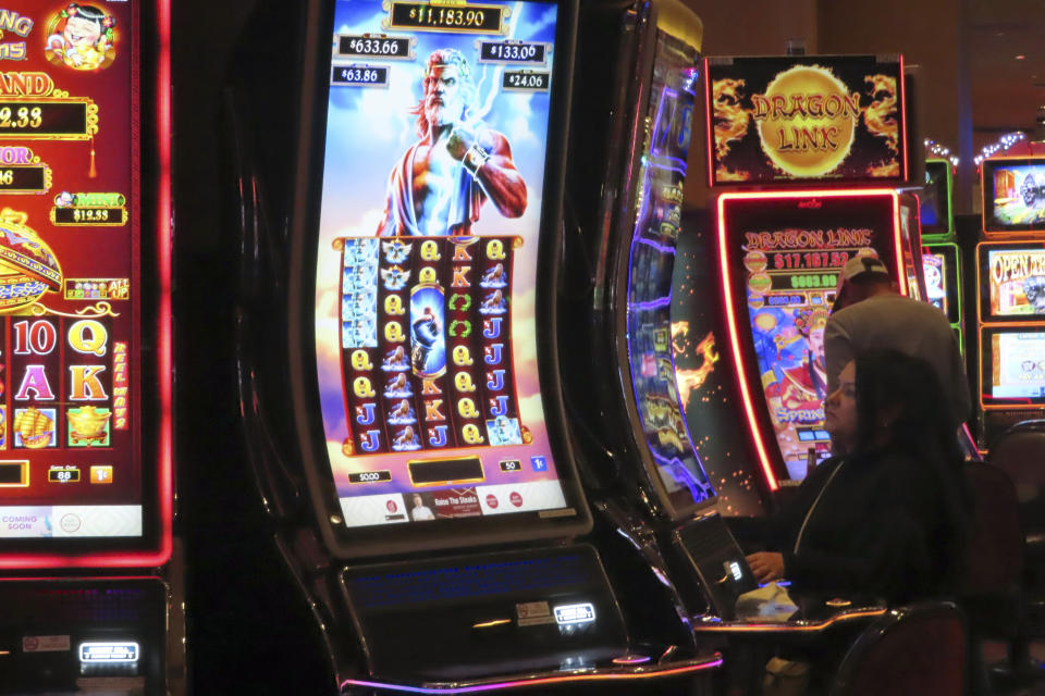 A gambler plays a slot machine at Harrah's casino in Atlantic City N.J. on Sept. 29, 2023. Figures released, Tuesday, April 16, 2024, show Atlantic City's casinos, their online partners and horse tracks that take sports bets won over $526 million in March, a month in which New Jersey's internet gambling market set yet another monthly record at $197 million. (AP Photo/Wayne Parry)