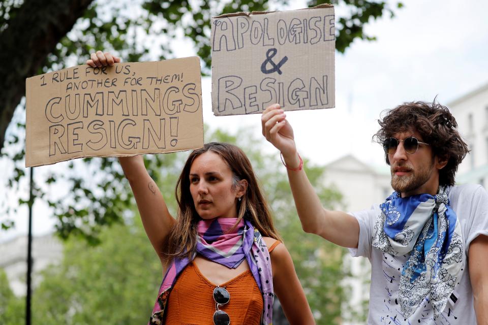 Protestors holding placards calling for there resignation or sacking of Number 10 special advisor Dominic Cummings demonstrate outside the entrance to Downing Street in central London on May 27, 2020. - British Prime Minister Boris Johnson saw his public support suffer the sharpest fall for a Conservative leader in a decade Wednesday as he prepared to be grilled by lawmakers over his handling of the Dominic Cummings scandal. Johnson has stuck by Cummings despite a public and political backlash over his top aide's travels to visit family despite the government's strict rules to curb the coronavirus pandemic. (Photo by Tolga AKMEN / AFP) (Photo by TOLGA AKMEN/AFP via Getty Images)