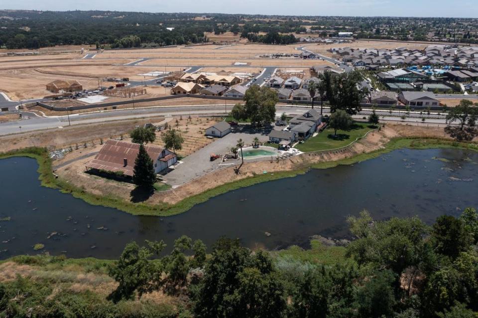 A ranch style home is surrounded by a new housing development in Lincoln in July. Lincoln’s population has grown from about 11,000 in 2000 to more than 52,000 today.