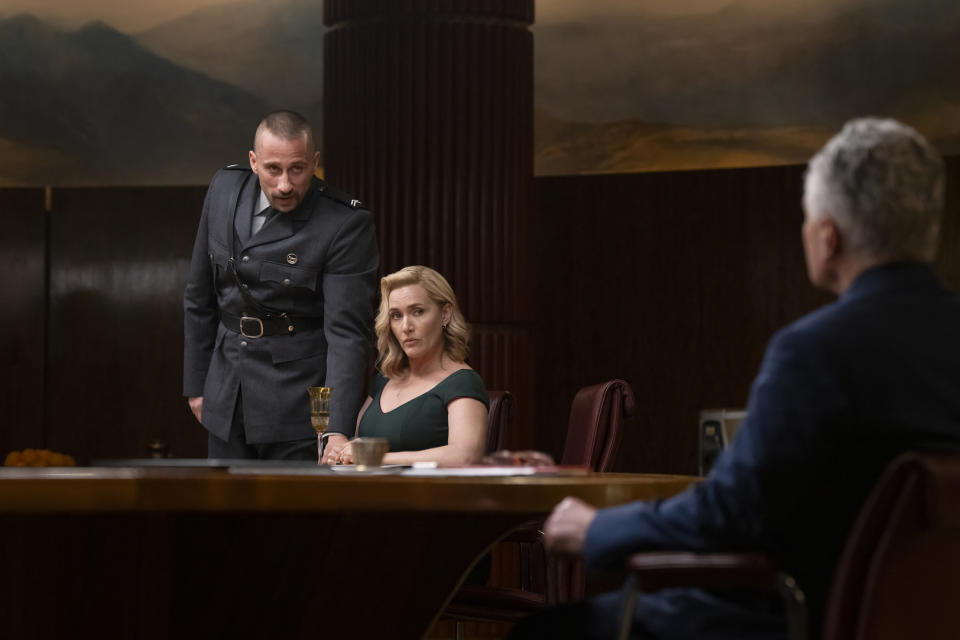 This image released by HBO shows Kate Winslet, center, and Matthias Schoenaerts, left, in a scene from "The Regime." (HBO via AP)