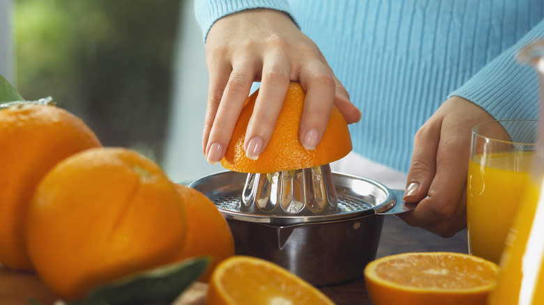 Oranges being squeezed for juice