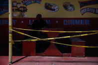 A man waits for his order in an outdoor dining area closed due to the coronavirus pandemic in the Vermont Square neighborhood of Los Angeles, Thursday, May 21, 2020. While most of California took another step forward to partly reopen in time for Memorial Day weekend, Los Angeles County didn't join the party because the number of coronavirus cases has grown at a pace that leaves it unable to meet even the new, relaxed state standards for allowing additional businesses and recreational activities. (AP Photo/Jae C. Hong)