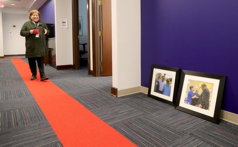 State & Federal Communications President & CEO Elizabeth Bartz walks down a long hallway that she calls Pennsylvania Avenue in her new offices Tuesday in Akron.