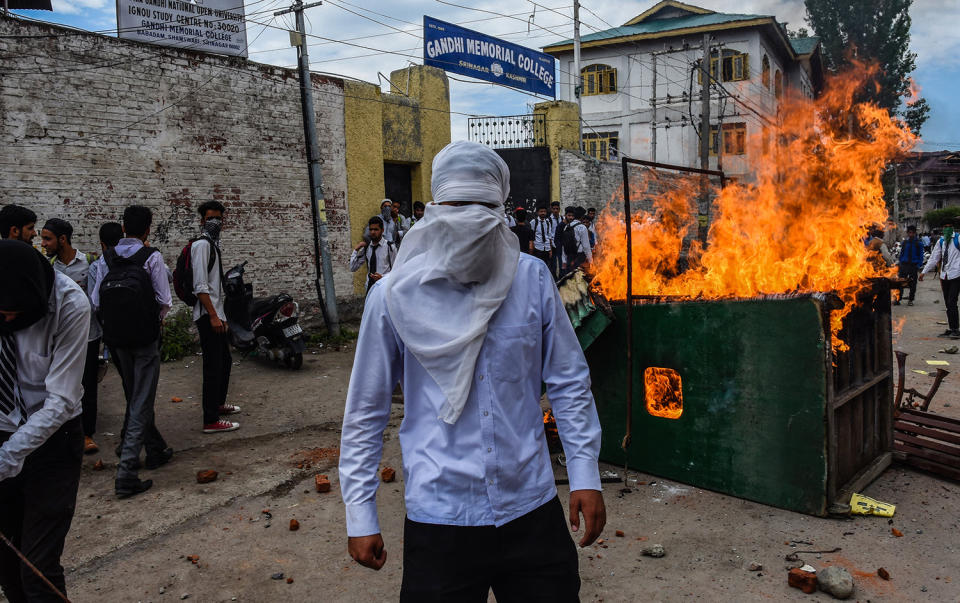 <p>A Kashmiri masked student looks towards the protesters during a fresh protest, against the attack by Indian government forces on students, on May 22, 2017, in Srinagar, the summer capital of Indian administered Kashmir, India. Indian police used force to break up fresh demonstrations by Kashmiri students against Indian rule. The students have taken to streets and clashed with Indian government forces several times since an attack by Indian forces on a college in south Kashmir’s Pulwama district last month. (Photo: Yawar Nazir/Getty Images). </p>